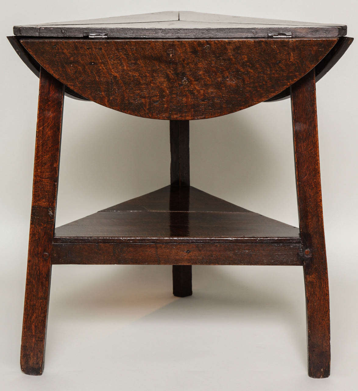 Rare 18th Century English or Welsh drop leaf cricket table, the triangular/round top of segmented construction, the top swiveling to be either shape, over splay leg base having square chamfered legs joined by lower shelf, the whole with good color