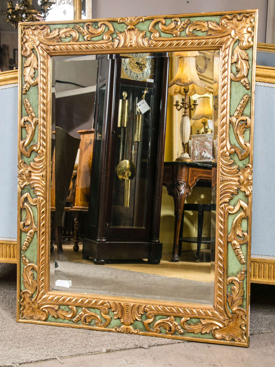 An early example of Jansen quality is exemplified in this green and parcel paint decorated wall mirror. The leaf and vine shell design in a wonderfully done gilt gold finish. The reverse with mortise and tenon joints.