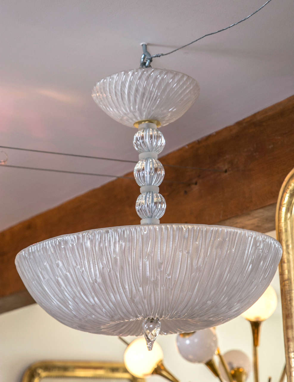 Shimmery Murano white chandelier comprised of a lovely textured bowl suspended with a stem containing four clear balls, opaque white disks and blown swirl canopy.
Electrified with five sockets of up to 60 watts each.