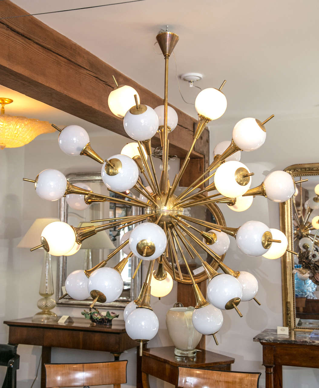 Fabulous Italian design; Stilnovo 1960s style round fixture with a brass center and 32 shooting arms with blown Murano balls that are all illuminated ready!
Very playful and fun to select which to illuminate or can have them all illuminated.
Each