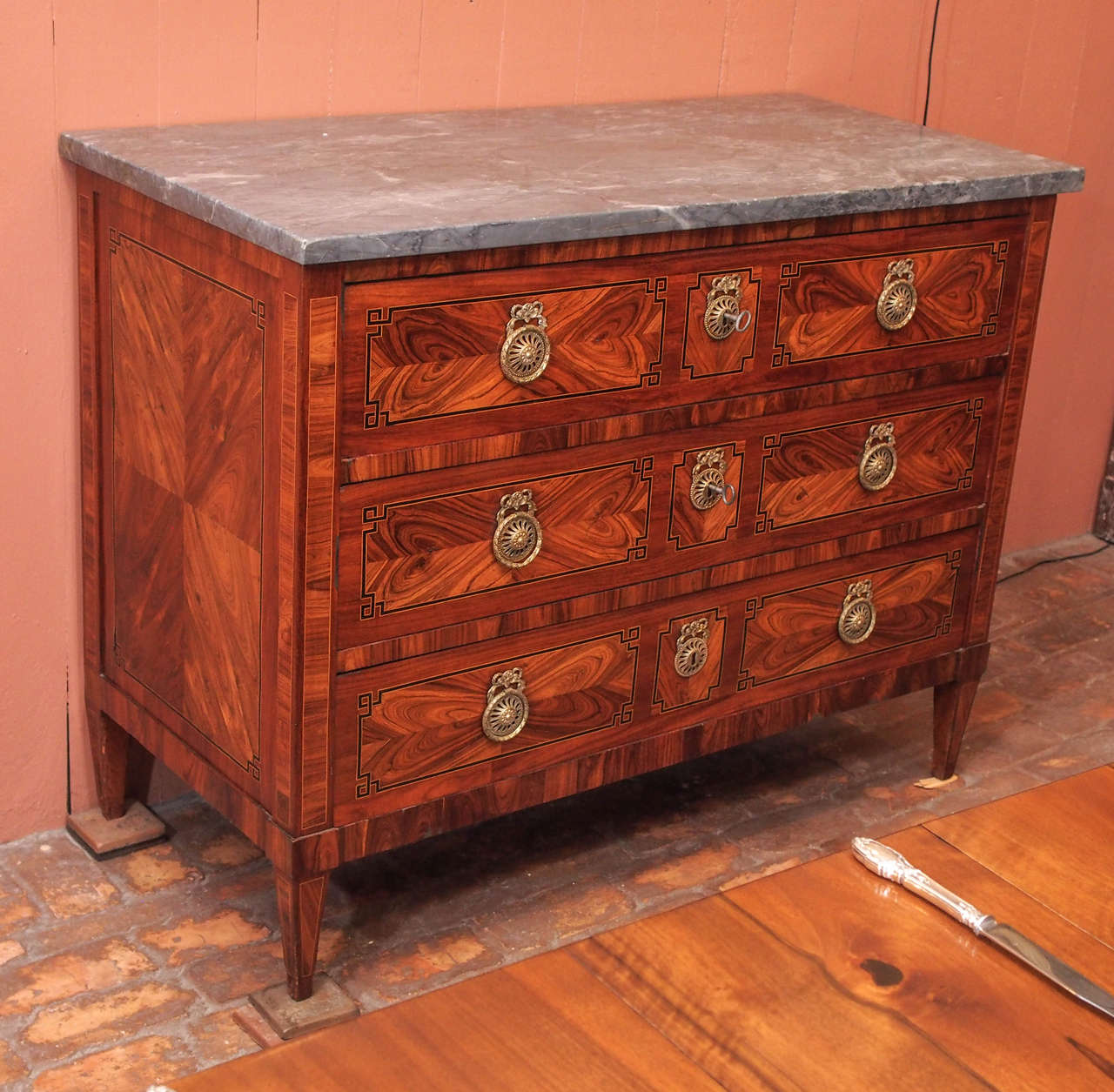 Fine French Louis XVI/Directoire transition mahogany marquetry commode with grey marble top, circa 1790.