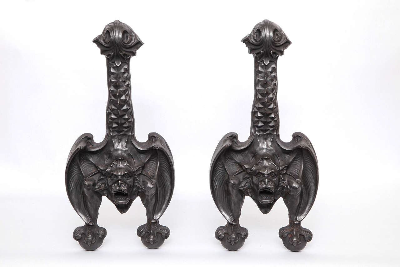 A pair of 1920s stylized bat andirons.