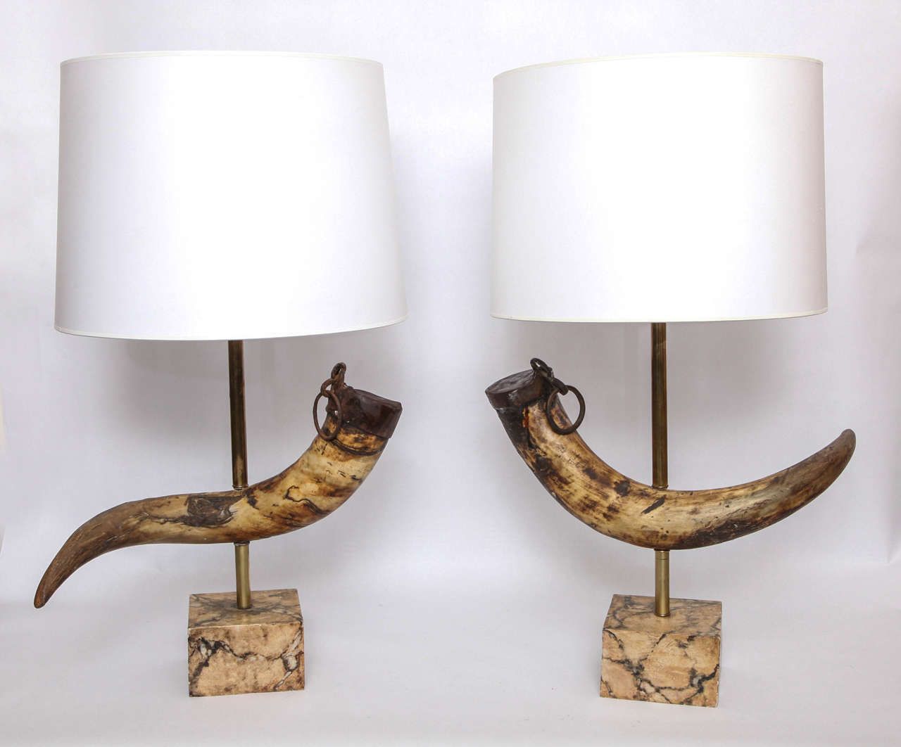 A pair of 1920s table lamps Prehistoric horns with hand-wrought iron mounts.
On faux marble bases, new sockets and rewired.
Shades not included