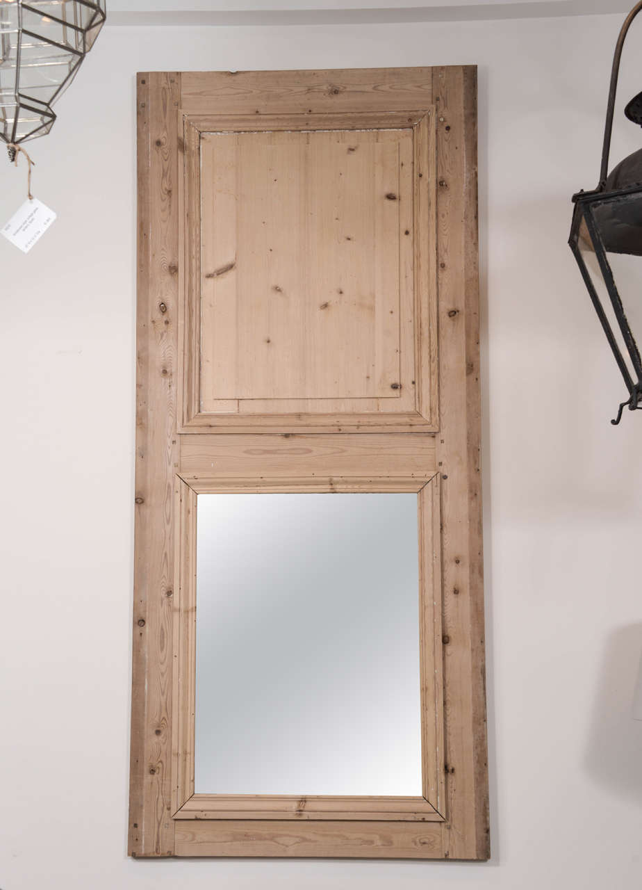 Near pair of 19th century stripped pine French trumeau mirrors.