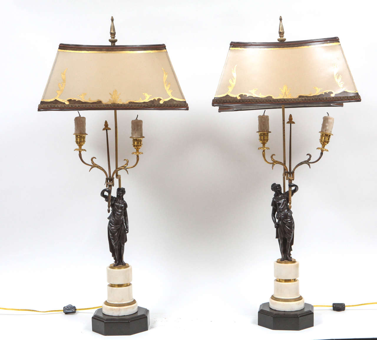 Pair of 19th century French marble and bronze candlesticks converted to lamps. They are very fine and French mounted. The shades are included and are handmade of parchment paper. They are hand gilded and decorated. The lamps have been newly wired.