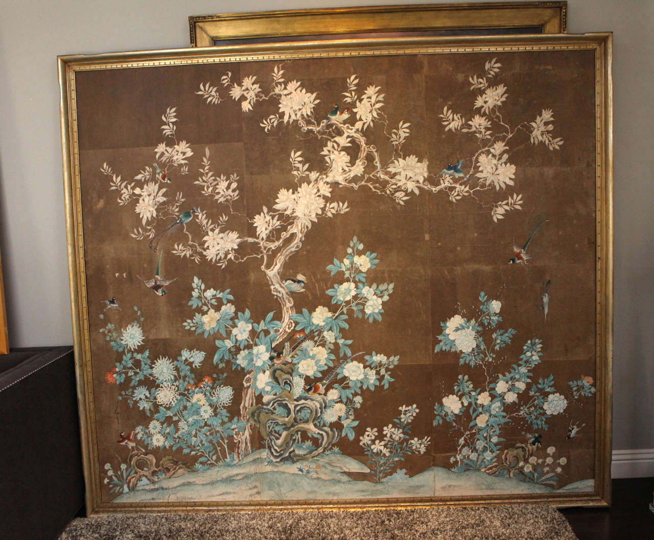 Early 19th century hand-painted Chinese wallpaper panels of colorful birds and foliage. Mounted in giltwood frame.