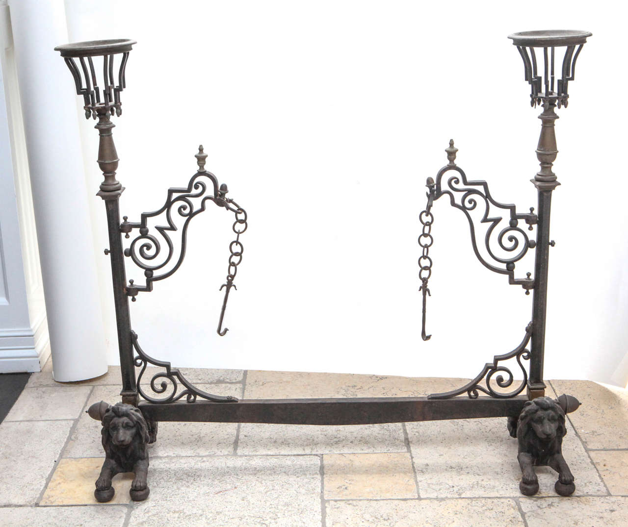 Late 19th century French bronze and wrought iron fireplace stand with lion base, acorn finial and 