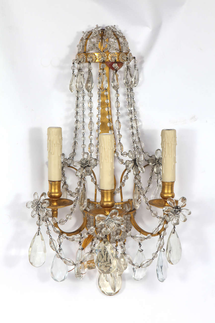 Very fine pair of 1900s French doré bronze and crystal sconces.