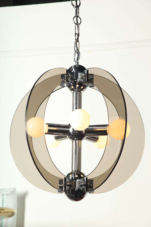 Exciting modernist chandelier made by Veca in 1965 in Milan.
Four smoked polished half round glass pieces set into a chrome frame.
Nice size.
 