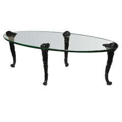 P. E Guerin Oval Glass Coffee Table With Black Carved Wood Legs