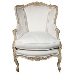 Carved french upholstered arm chair .