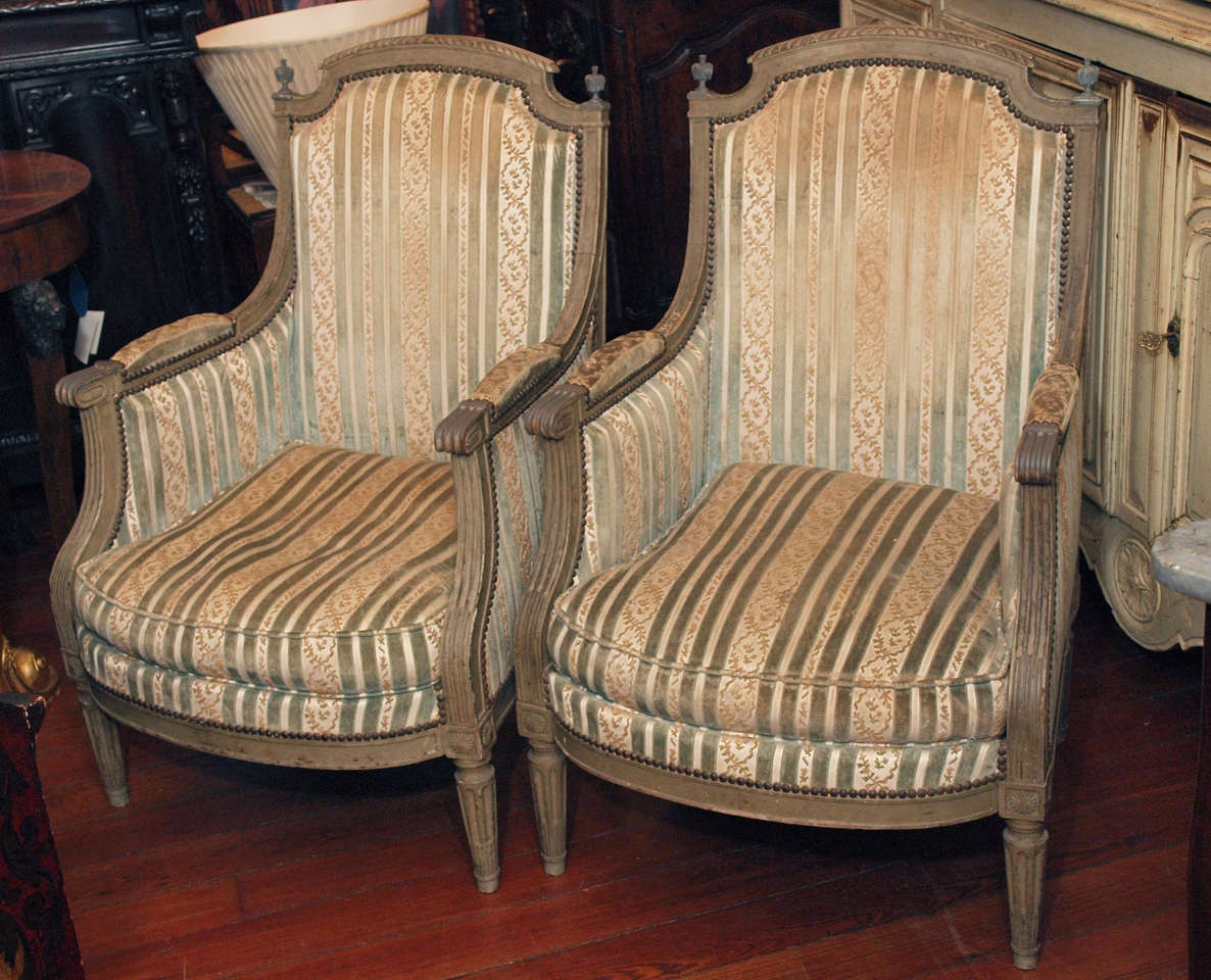 Pair of Louis XVI painted bergeres with loose cushion.
  