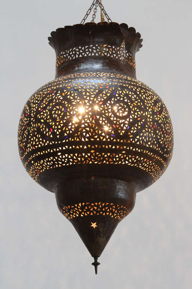 Large handcrafted Moroccan Moorish pierced brass hanging lantern with very nice dark bronze finish patina. Adorned with hand-blown glass, finely incised, pierced and hammered with geometric design that will reflect on the walls and ceiling when