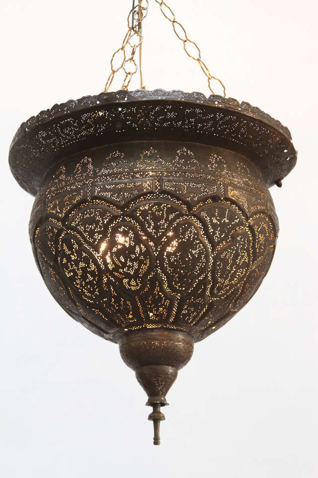 Early 19th century Antique filigree pierced brass Turkish Mosque Lamp.
Unique ceiling fixture pierced with very fine Ottoman Islamic calligraphy, foliage and scenes.
Rewired for electricity.
Great patina


Mosaik provides Antiques, Moorish Style