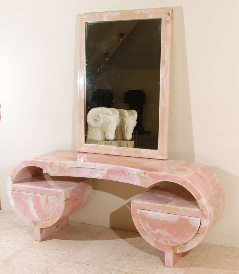This Unique Art Deco vanity and mirror which is quintessential Hollywood glamour is fabulous in every way. The pink marble vanity is accompanied by a matching mirror. The drawer mechanisms have been updated.