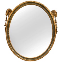 Miroir ovale de style néoclassique français avec peinture à motif de tête de bélier et doré