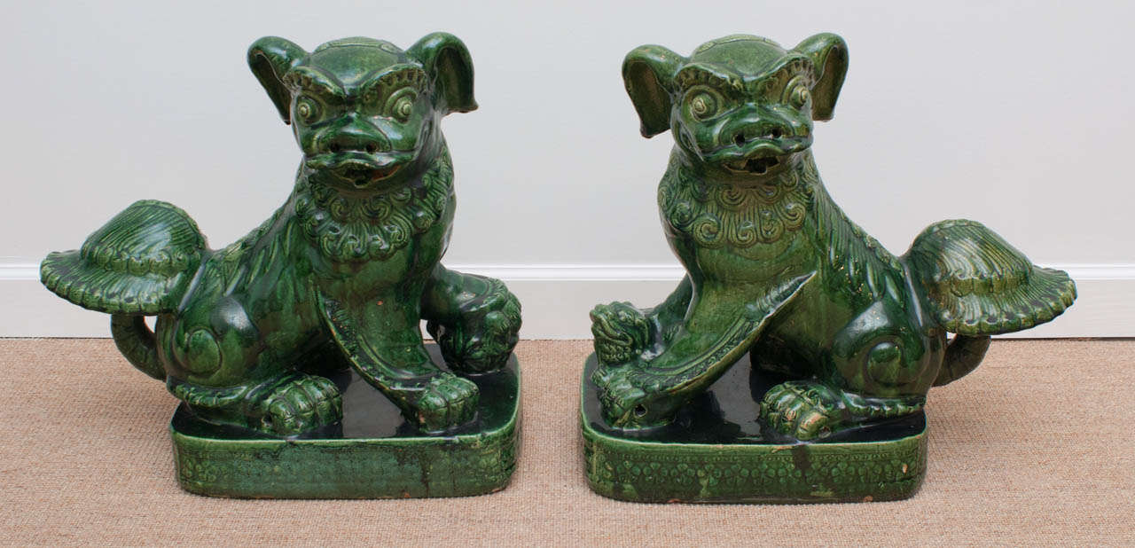 A fine and large pair of Chinese glazed pottery foo dogs circa 1920.