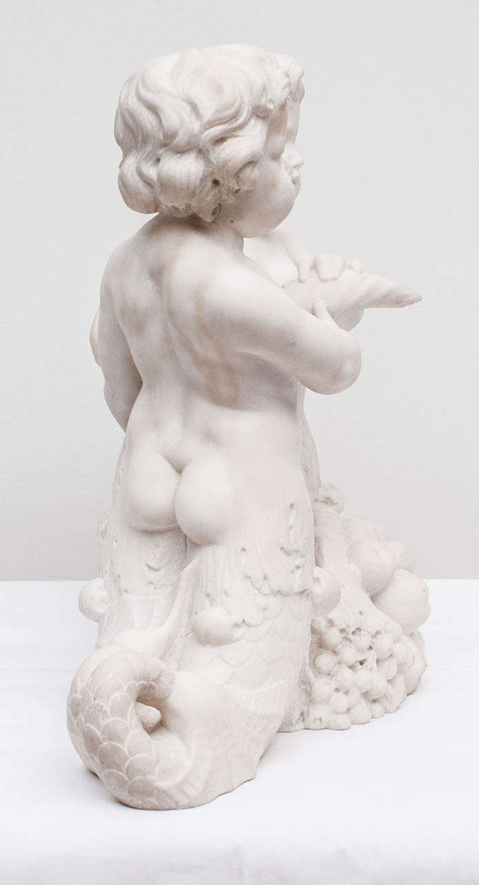 20th Century Italian Carved Carrera Marble Dolphin-Tailed Cherubs For Sale