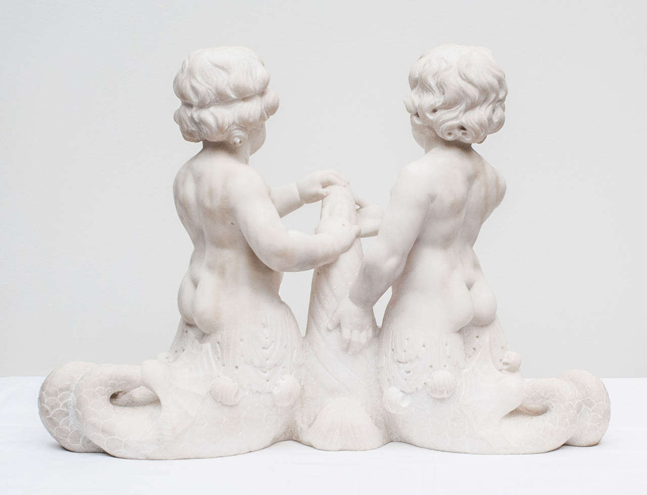 Italian Carved Carrera Marble Dolphin-Tailed Cherubs For Sale 1