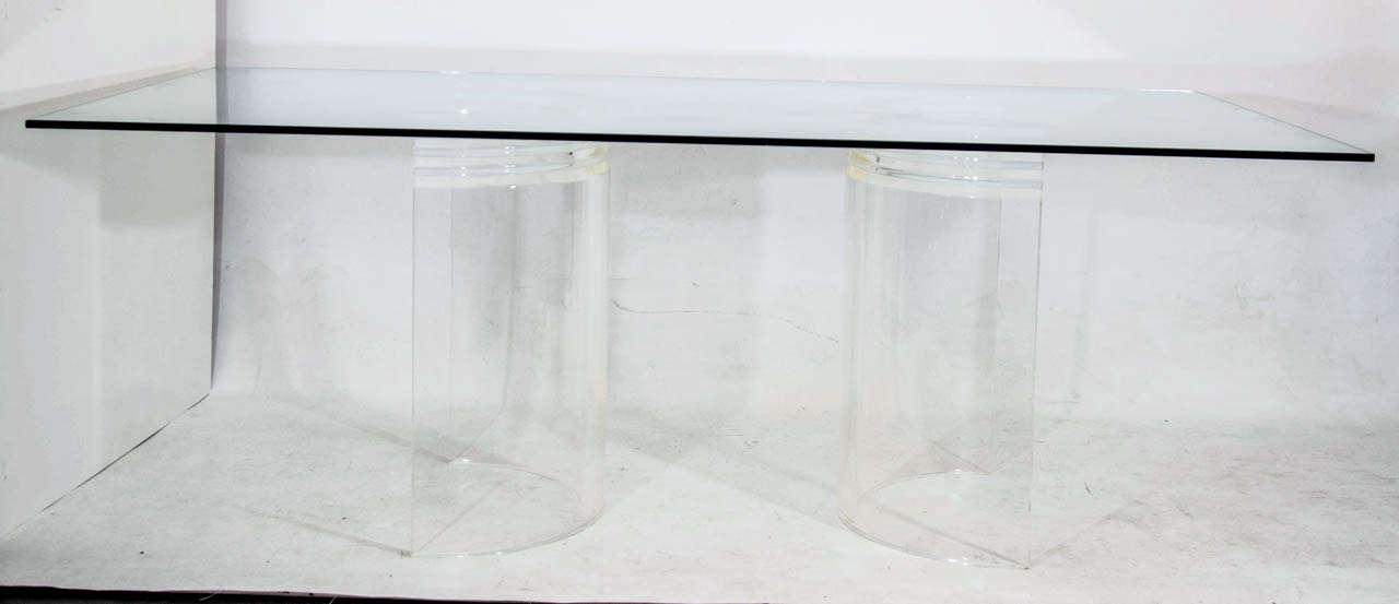 Dining or desk table with two sculptural lucite supports topped with glass. Please contact for location.