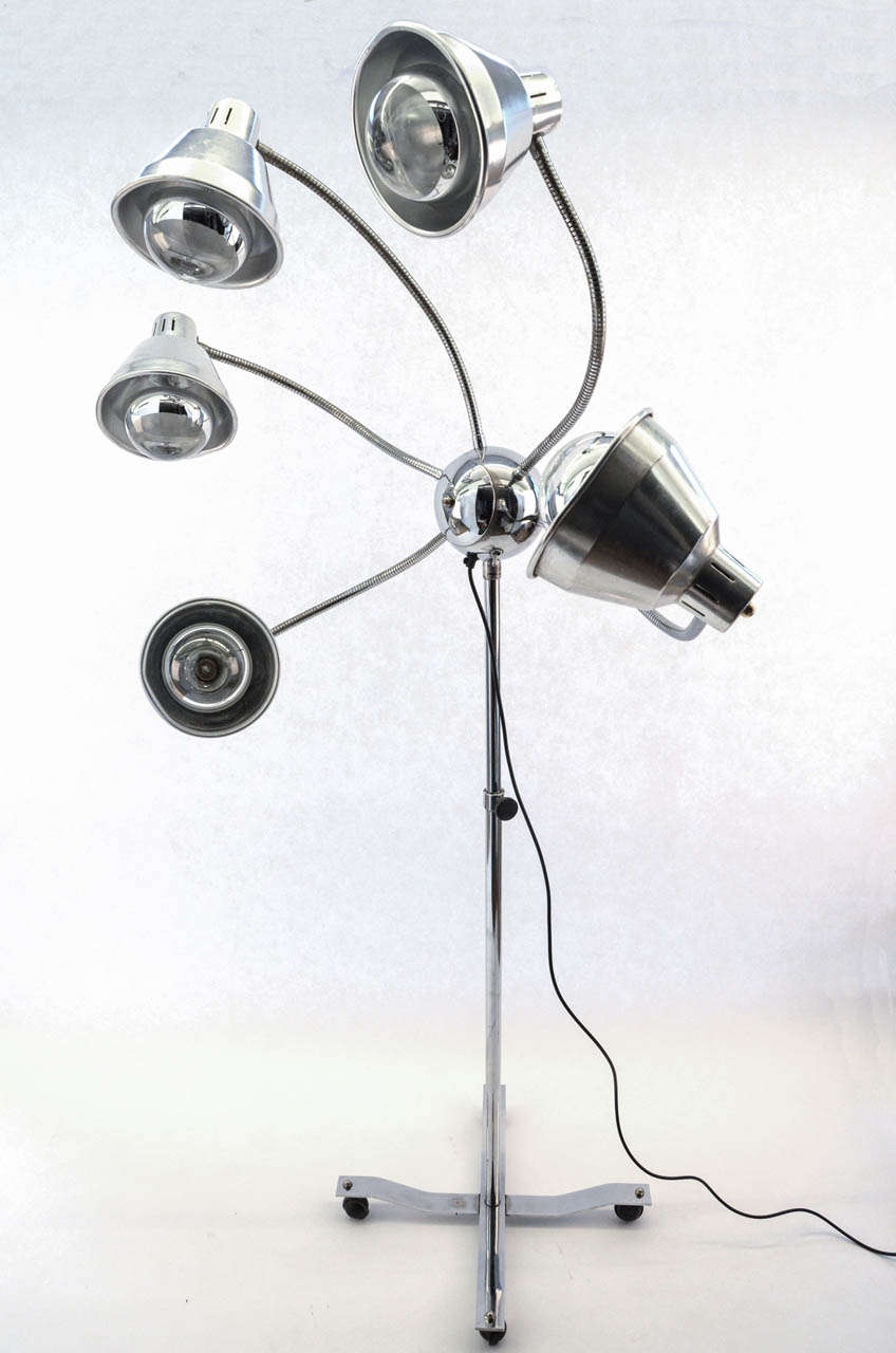 This unique octopus floor lamp from the 1960s. Stands on a stainless steel adjustable (height) base on wheels. The arms are totally flexible with regards to positioning. The lamp shades are aluminum (manufacturer unknown.)