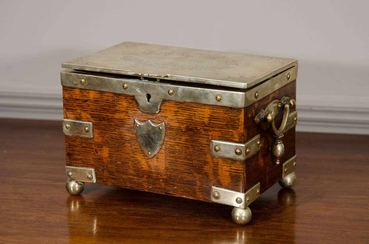 19th century silver bound oak tea caddy with engraved top and two internal compartments.
