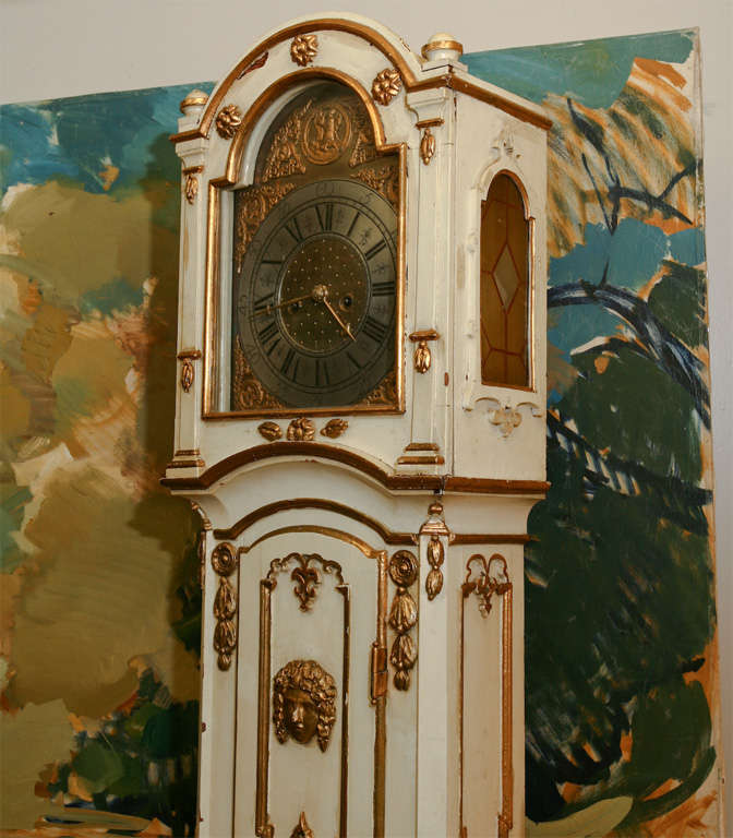 A Danish white painted and gilt decorated longcase clock, brass dial, openwork corner ornaments, chapter ring of pewter, late 18th century. Measures: H 215 cm.