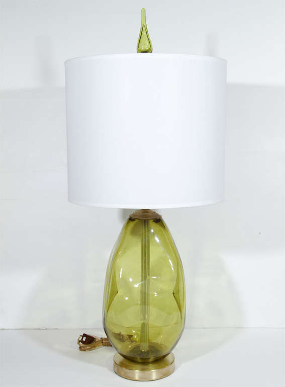Pair of pinched green glass glass lamps with green glass finials on satin brass disc bases. Visit Quotientnyc.com to view our complete collection.