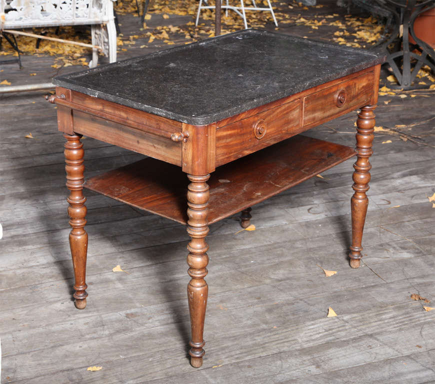 A Figured Mahogany 2 Tiered Table with Recessed Round Pulls