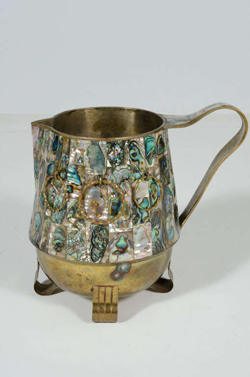 A marvelous water pitcher overlaid with abalone shell and twisted brass rings by Salvador Teran. Mexico, circa 1950.