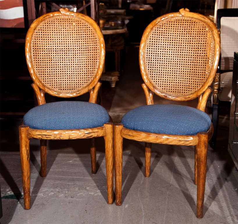 Pair of French Louis XIV style side chairs, each with oval caned back, blue upholstered padded seat, raised on circular tapering legs.