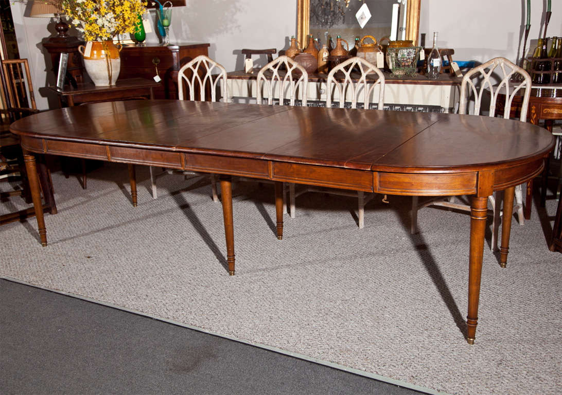 French Provincial mahogany dining table, late 19th century, oval ends supported by 6 circular tapering legs, comes with 4 additional leaves each measures 17.5