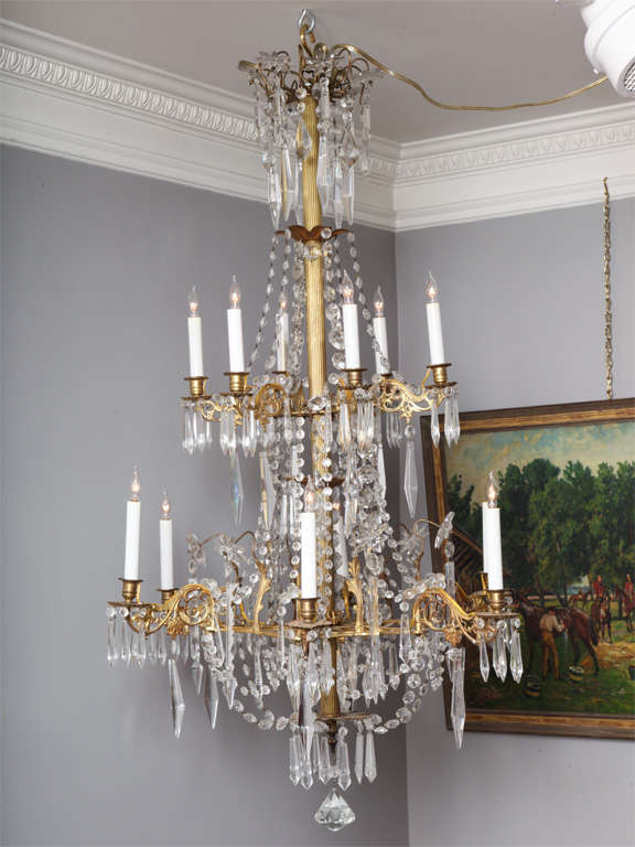 Very fine twelve-light cut crystal and ormolu chandelier, having star-shaped finials with pendant drops above swags and scrolled arms with beading and foliage and stamped pans, in wonderful original condition with all original crystals and pinnings,