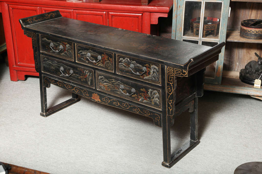 This vintage black lacquered five-drawer buffet from the mid-20th century features the typical Chinese shape, reminiscent of altar tables. The top and drawers are painted with an incredible finesse in an antique Chinese manner, with some typical