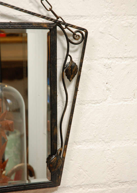 A good French wrought iron framed wall mirror. The rectangular mirror is a good size and is in an iron frame that has three outer extensions having decorative floral elements. 
