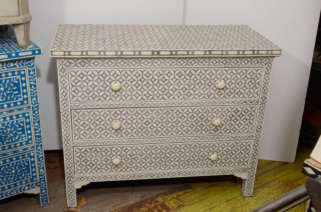 3 drawer hand inlaid grey and white cabinet with a classic geometric pattern.  Camel bone inset in resin laminated on wood. Grey is darker than pictured

$4,500 each or $6,500 for the pair