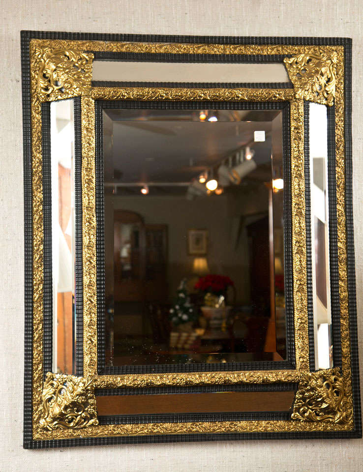 With its brass relief frame accented by ebonized trim and beveled glass, this Venetian mirror offers a stately option for just about any decor. Beveled glass is used in the frame, giving extra side light reflection and a handsome appearance.