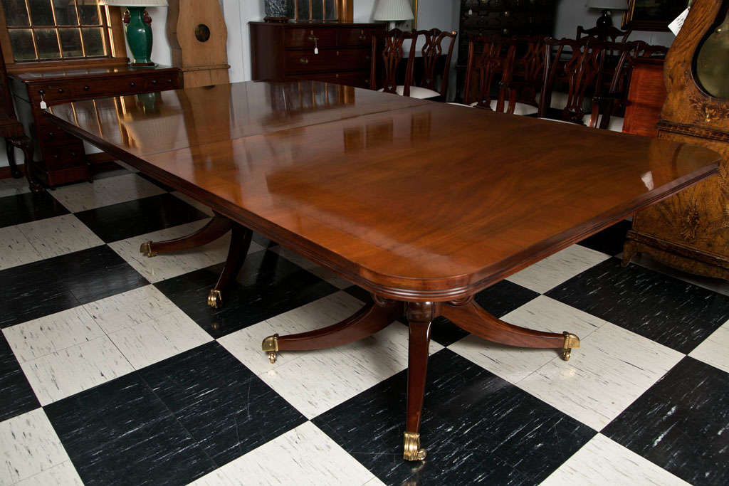 Handcrafted for us in Cuban mahogany in William IV style, this double pedestal dining table can seat up to 14. Excellent proportions and a superb antique finish define this table. From its thick, fluted edge to the strong, four-leg pedestals, this