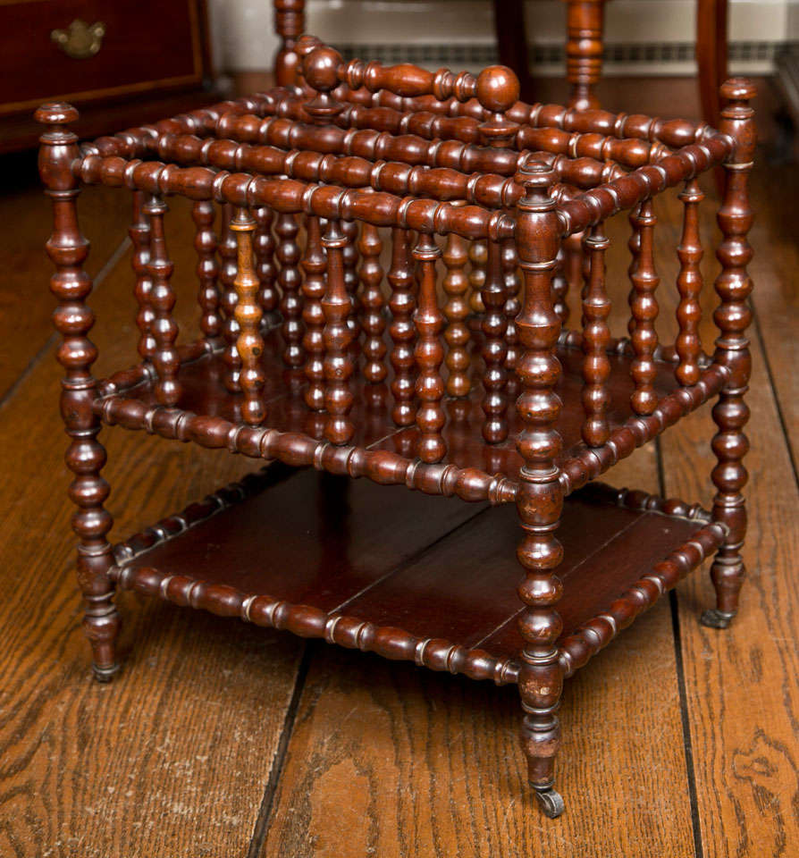 Popular in mid-19th century England, bobbin turning showcased the wood turning skills of craftsmen of the era. Sporting no fewer than 38 individually turned pieces of mahogany, this little canterbury, or magazine cart, is a superb example of the