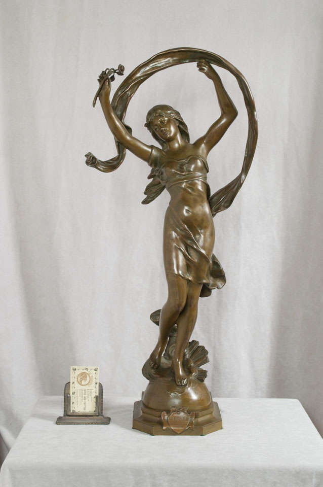 This graceful and flowing young girl is a fine example of sculpture from the art nouveau period.  Beautiful warm brown patina and expressiveness highlight this beautiful piece of sculpture.  The piece is titled and is signed by the noted French