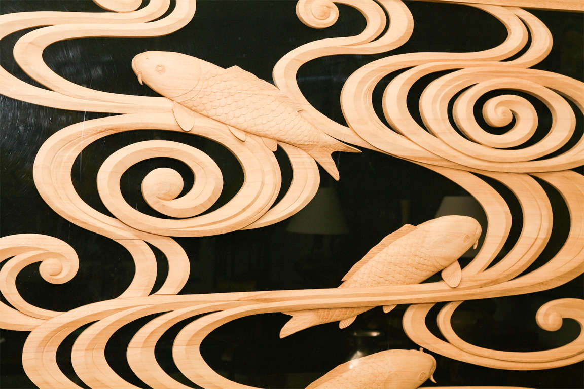 Japanese wood carving panel of swimming carp in turbulent waters, circa 1900.