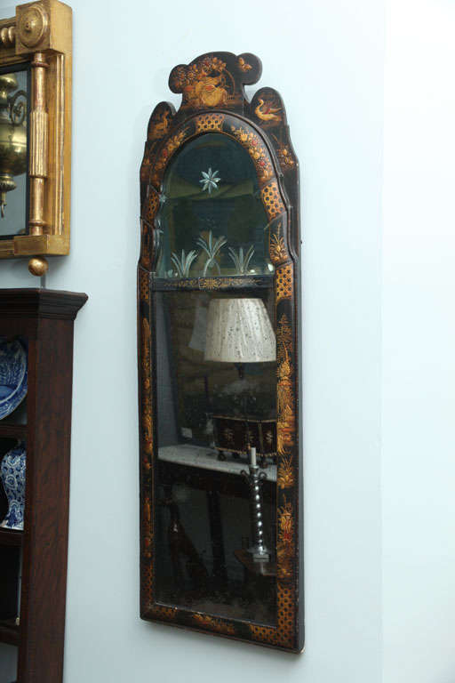Very fine Queen Anne period japanned mirror, the shaped crest over arched, beveled and cut designed top plate, beveled and eglomise border glass, and later lower plate, the frame beautifully decorated with chinoiserie scenes.