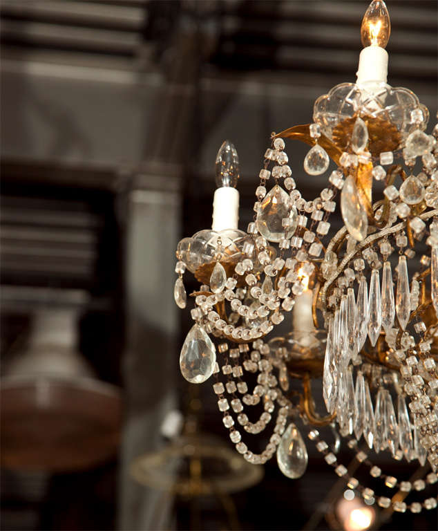 A grand, eight light, Italian, tole gilt metal and crystal beaded neoclassical balloon form chandelier with French influence. 

Second one available. 