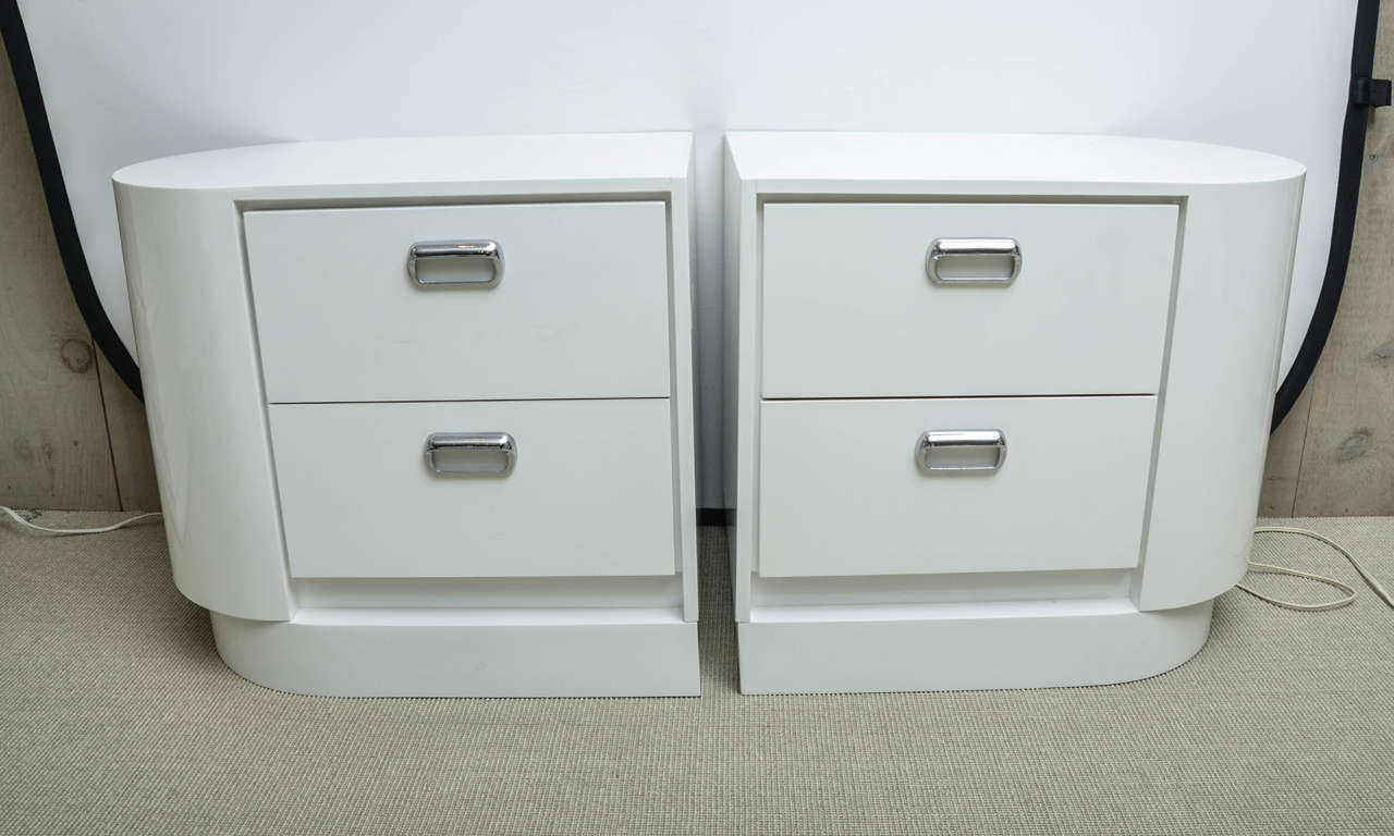 Unusual pair of vintage white lacquer right and left two-drawer nightstands with chrome drawer pulls.