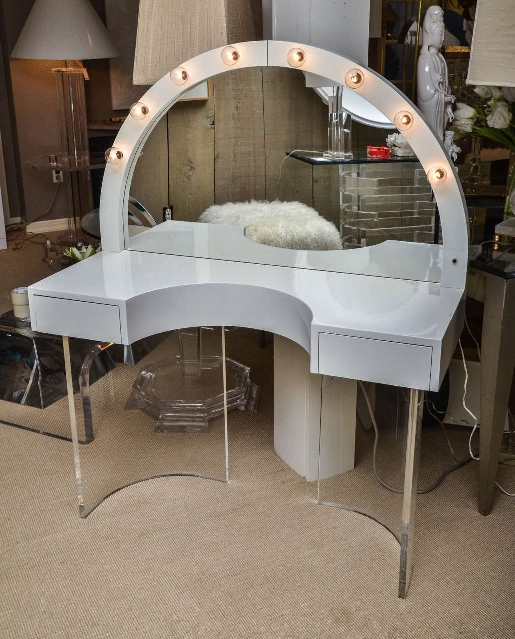 Attractive vintage white lacquer two-drawer vanity with Lucite base and attached white lacquer mirror.