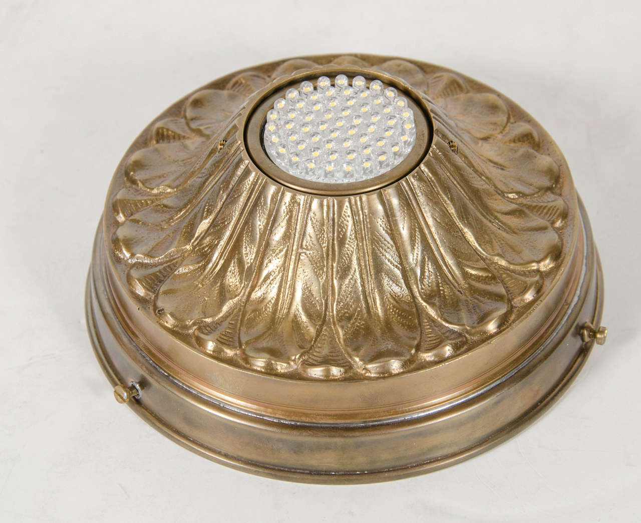 This spotlight depicts a stylized acanthus design in patinated brass in relief form. This is fitted for a halogen bulb and has been completely rewired as well.