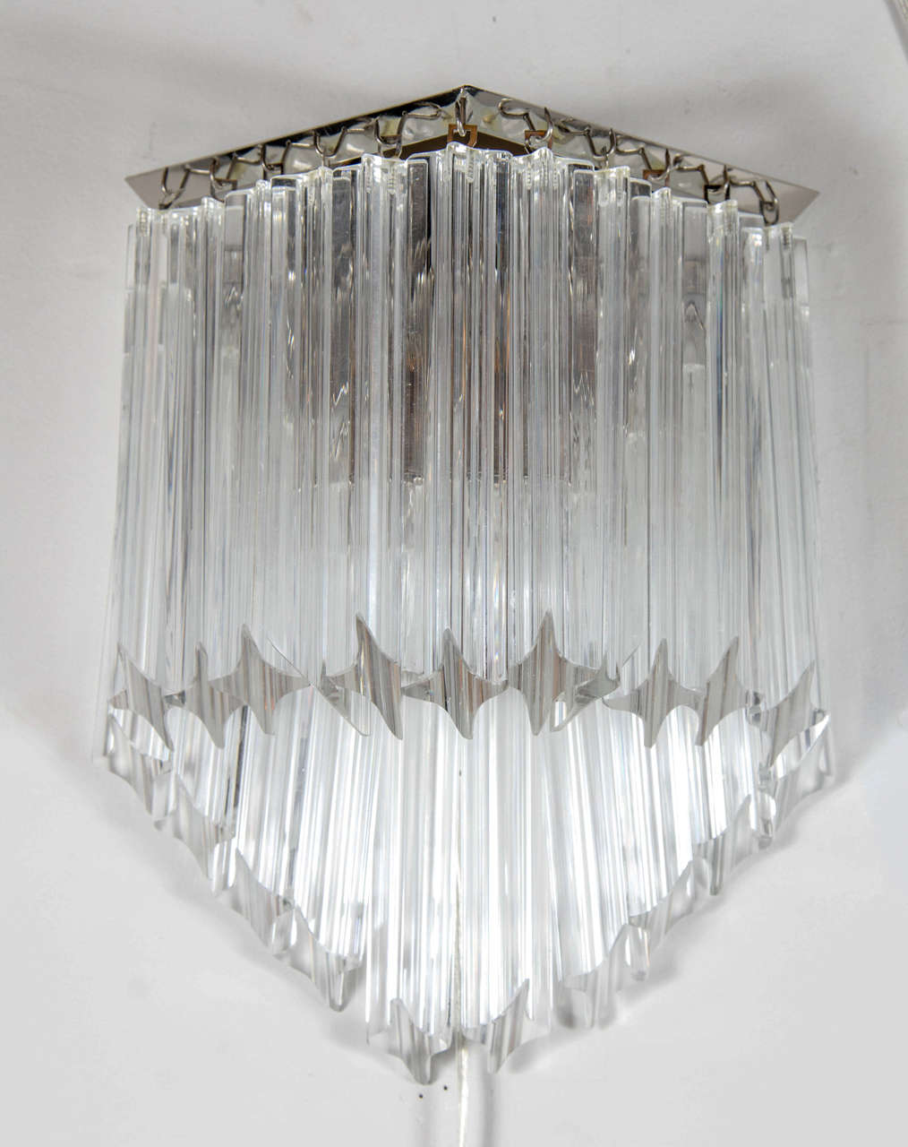 Pair of Mid-Century Modernist Triedre cut-crystal Camer sconces. This pair of sconces is comprised of individually hung Camer Triedre cut-crystal rods, descending from top to bottom, in a stylized angular formation. The sconces extend from a round