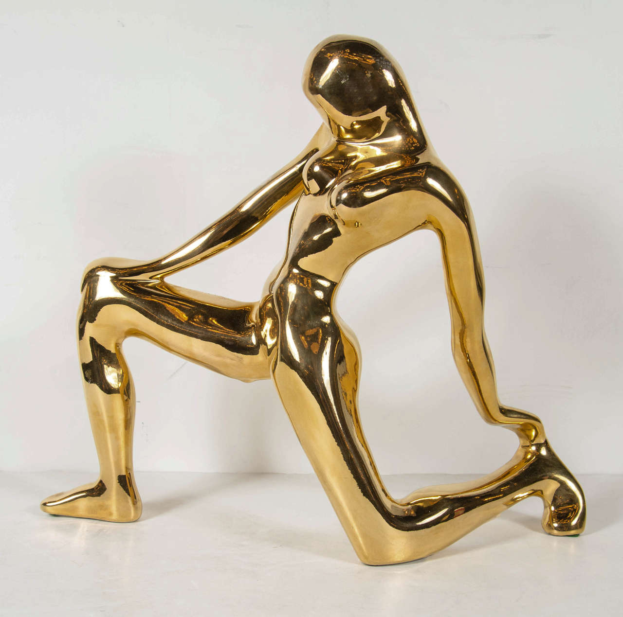 This gold-plated ceramic sculpture features a stylized kneeling woman in Cubist form. It bears the signature Jaru on the bottom.