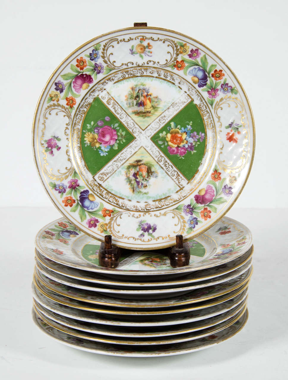 These porcelain desert plates are hand decorated with hand  painted foliage and colonial decoration embellished in 24k yellow gold.They are signed Schumann Dresden Art  Bavaria.They would mix in beautifully with modern to add an elegant and