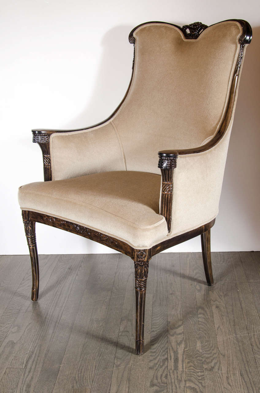 This gorgeous pair of 1940s Hollywood occasional chairs by Grosfeld House consist of a hand-carved walnut frame with elegant detailing  including sweeping arms, a contoured seat and back for maximum comfort and support, fine splayed legs and new